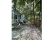 The overgrown backyard featuring building supplies and debris that needs cleaning up and some landscape maintenance at 8373 Chicago Ave, Douglasville, GA 30134