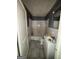 Modest, outdated bathroom featuring a standard tub, toilet, vanity, and tiled walls needing updates at 8373 Chicago Ave, Douglasville, GA 30134