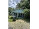 Charming single-story home featuring a quaint front porch, light blue siding, and an unkempt front yard at 8373 Chicago Ave, Douglasville, GA 30134