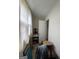 Hallway featuring dated flooring, drab walls, and natural light from a window at 8373 Chicago Ave, Douglasville, GA 30134