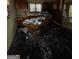 Dated kitchen featuring black flooring, drab walls, wood cabinets, and natural light from one window at 8373 Chicago Ave, Douglasville, GA 30134