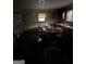 Dated kitchen featuring black flooring, drab walls, wood cabinets, and natural light from one window at 8373 Chicago Ave, Douglasville, GA 30134