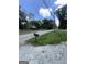 Street view of home with trees and shrubs in the front yard and a road in front of the house at 8373 Chicago Ave, Douglasville, GA 30134