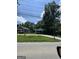 Street view of home with trees and shrubs in the front yard and a road in front of the house at 8373 Chicago Ave, Douglasville, GA 30134