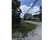 Street view of home with trees and shrubs in the front yard and a road in front of the house at 8373 Chicago Ave, Douglasville, GA 30134