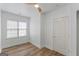 Minimalist bedroom with a window, wood flooring, and a white door, creating a bright and airy atmosphere at 995 Lena Nw St, Atlanta, GA 30314