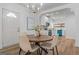 Charming dining area with modern chandelier, hardwood floors, and a view into the stylish, updated kitchen at 995 Lena Nw St, Atlanta, GA 30314