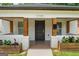 Inviting front porch with brick planters, wooden posts, and a charming entrance with the house number above the door at 995 Lena Nw St, Atlanta, GA 30314