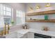 Charming kitchen with open shelving, undermount sink, gold faucet, and a window for natural light at 995 Lena Nw St, Atlanta, GA 30314