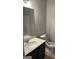 Cozy bathroom featuring a vanity with a sink, a toilet, and a large mirror at 3810 Equity, Powder Springs, GA 30127