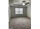 This bedroom features neutral walls, plush carpet, tray ceiling, and a window with blinds for natural light at 3810 Equity, Powder Springs, GA 30127