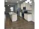 Modern kitchen featuring stainless steel appliances, granite countertops, and a spacious island at 3810 Equity, Powder Springs, GA 30127