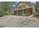 Expansive two-story home with a spacious wooden deck, lower-level access, and a covered parking area at 6220 Petersburg Rd, Fairburn, GA 30213