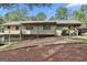 Exterior of the house from the backyard, featuring a deck, stairs, and wooded landscape at 6220 Petersburg Rd, Fairburn, GA 30213
