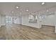 Expansive finished basement featuring wood-look floors and a convenient kitchenette with granite countertops at 6220 Petersburg Rd, Fairburn, GA 30213