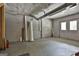 Unfinished basement area with cement floor, block walls, and door to the backyard at 6220 Petersburg Rd, Fairburn, GA 30213