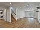 Finished basement with laminate flooring, access to the backyard, stairs to first floor, and laundry room at 6220 Petersburg Rd, Fairburn, GA 30213