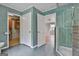Stylish bathroom with a mosaic tile design, open closet and glass shower at 6220 Petersburg Rd, Fairburn, GA 30213
