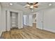 Bedroom featuring wood-look flooring, a ceiling fan, closet, and doorways at 6220 Petersburg Rd, Fairburn, GA 30213