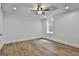 Bedroom featuring wood-look flooring, a ceiling fan, and natural light from a window at 6220 Petersburg Rd, Fairburn, GA 30213