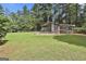 This spacious backyard features a large wooden chicken coop at 6220 Petersburg Rd, Fairburn, GA 30213