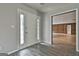 Bright foyer featuring a white front door with glass panels and wood-look flooring, leading to other living spaces at 6220 Petersburg Rd, Fairburn, GA 30213
