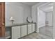 Hallway featuring built-in cabinets with tile countertop and open doorway at 6220 Petersburg Rd, Fairburn, GA 30213