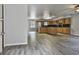 Open-concept kitchen with island, wooden cabinets, stainless steel appliances, and modern flooring at 6220 Petersburg Rd, Fairburn, GA 30213