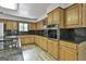 A kitchen showcases wood cabinets, granite countertops, and stainless steel appliances at 6220 Petersburg Rd, Fairburn, GA 30213