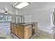 A kitchen shows wood cabinets and a large island with granite countertops at 6220 Petersburg Rd, Fairburn, GA 30213