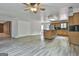Open kitchen with island, wooden cabinets and a stainless steel refrigerator at 6220 Petersburg Rd, Fairburn, GA 30213