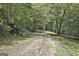 Scenic view of a dirt path winding through a forest landscape at 6220 Petersburg Rd, Fairburn, GA 30213