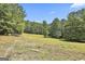 Expansive acreage lot with lush greenery and mature trees offers privacy and a tranquil setting at 6220 Petersburg Rd, Fairburn, GA 30213