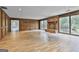 Spacious living room features a stone fireplace and large windows offering scenic views at 6220 Petersburg Rd, Fairburn, GA 30213