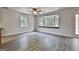 Spacious living room featuring a bay window, wood-look flooring, and neutral walls at 6220 Petersburg Rd, Fairburn, GA 30213