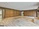 Spacious living room with a fireplace and wood paneling at 6220 Petersburg Rd, Fairburn, GA 30213