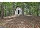 Wood outbuilding amongst trees, suitable for storage or workshop, with a rustic charm at 6220 Petersburg Rd, Fairburn, GA 30213