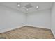 Room featuring wood-look flooring, neutral walls, recessed lighting, and a drop ceiling at 6220 Petersburg Rd, Fairburn, GA 30213