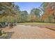 Spacious brick patio with seating area overlooking a large, private backyard and lush trees at 375 Darren Dr, Fayetteville, GA 30215