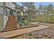 Expansive backyard featuring brick patio, steps, and landscaped garden leading to wooded property at 375 Darren Dr, Fayetteville, GA 30215