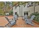 Outdoor brick patio featuring seating, complemented by home's exterior and landscaped garden at 375 Darren Dr, Fayetteville, GA 30215