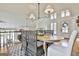 Bright dining room features wood table, seating for six, and windows that bring in natural light and views at 375 Darren Dr, Fayetteville, GA 30215