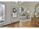 Bright entryway featuring hardwood floors, a frosted glass door, and a staircase at 375 Darren Dr, Fayetteville, GA 30215