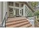 Inviting entryway with brick steps, a decorative wreath, and tasteful potted plants at 375 Darren Dr, Fayetteville, GA 30215