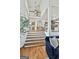 Bright foyer boasts hardwood stairs and natural light streaming through the windows, creating a warm entrance at 375 Darren Dr, Fayetteville, GA 30215