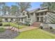 Exterior view featuring an elegant entryway with brick steps and professionally landscaped gardens at 375 Darren Dr, Fayetteville, GA 30215