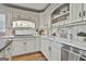 Bright kitchen with marble countertops, stainless steel appliances, custom cabinetry, and open shelving at 375 Darren Dr, Fayetteville, GA 30215