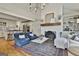 Spacious living room connecting to kitchen with a fireplace, hardwood floors, and white color palette at 375 Darren Dr, Fayetteville, GA 30215