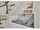 Staircase reading nook features cushion, pillows and built in shelves at 375 Darren Dr, Fayetteville, GA 30215