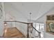Hallway with wooden banister, hardwood floors, and large windows with natural light at 375 Darren Dr, Fayetteville, GA 30215